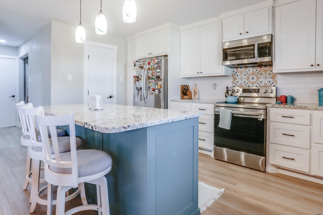 4306 57th Street Lubbock, TX 79413 - Photo 12 of 23 a kitchen with stainless steel appliances granite countertop a stove a sink dishwasher and a refrigerator