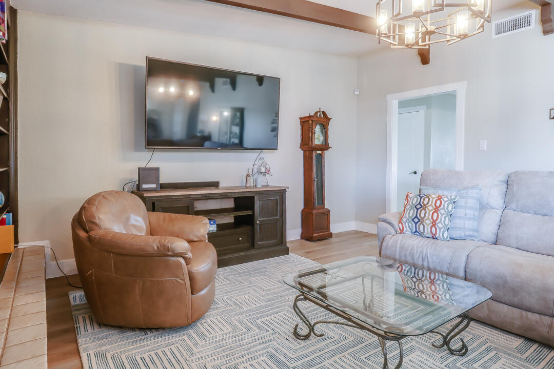 4306 57th Street Lubbock, TX 79413 - Photo 18 of 23 a living room with furniture and a flat screen tv