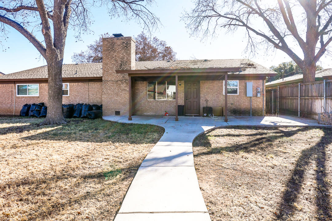 4306 57th Street Lubbock, TX 79413 - Photo 20 of 23 a front view of a house with a yard and potted plants