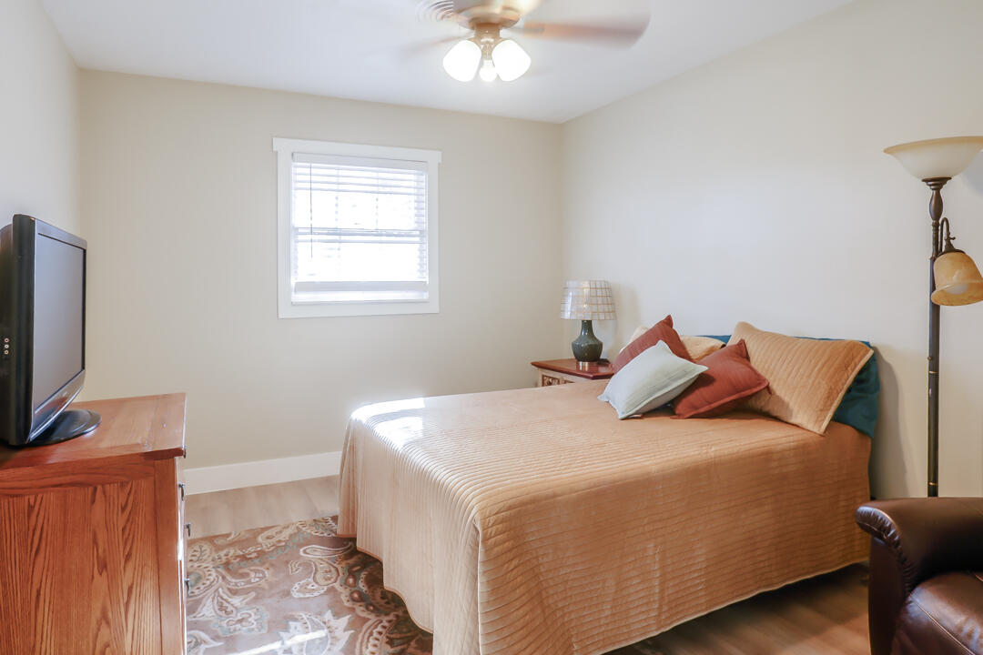 4306 57th Street Lubbock, TX 79413 - Photo 4 of 23 a bedroom with a bed and a flat screen tv