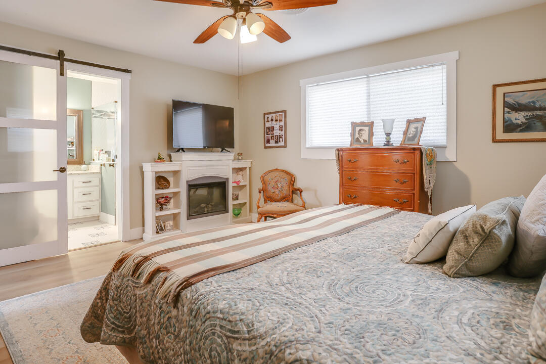 4306 57th Street Lubbock, TX 79413 - Photo 8 of 23 a bedroom with a bed and a flat screen tv