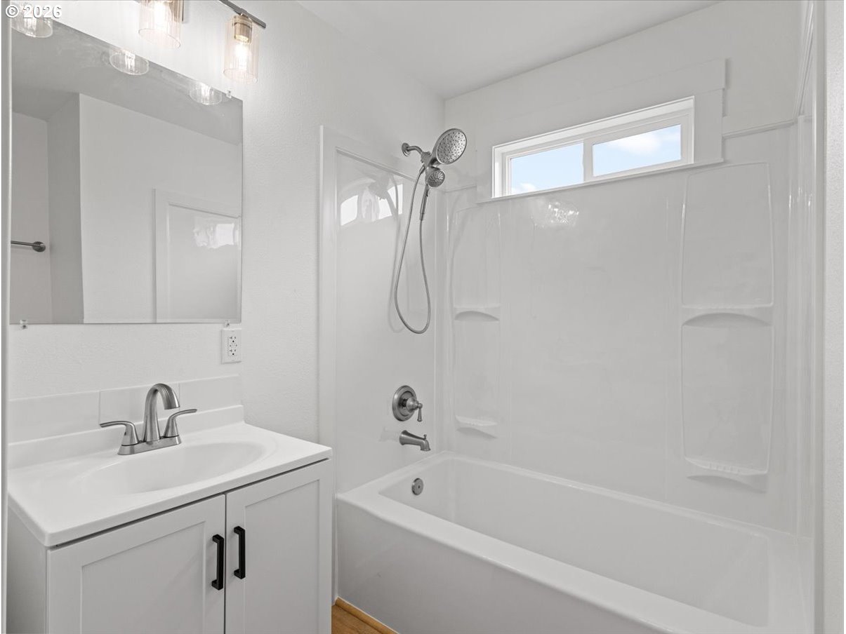440 25th Avenue Longview, WA 98632 - Photo 8 of 27 a bathroom with a sink a mirror and a shower