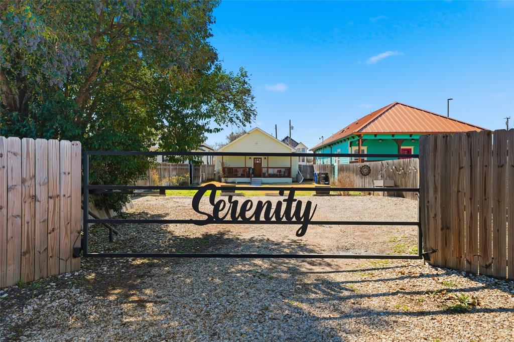 a view of a park with a bench and wooden fence
