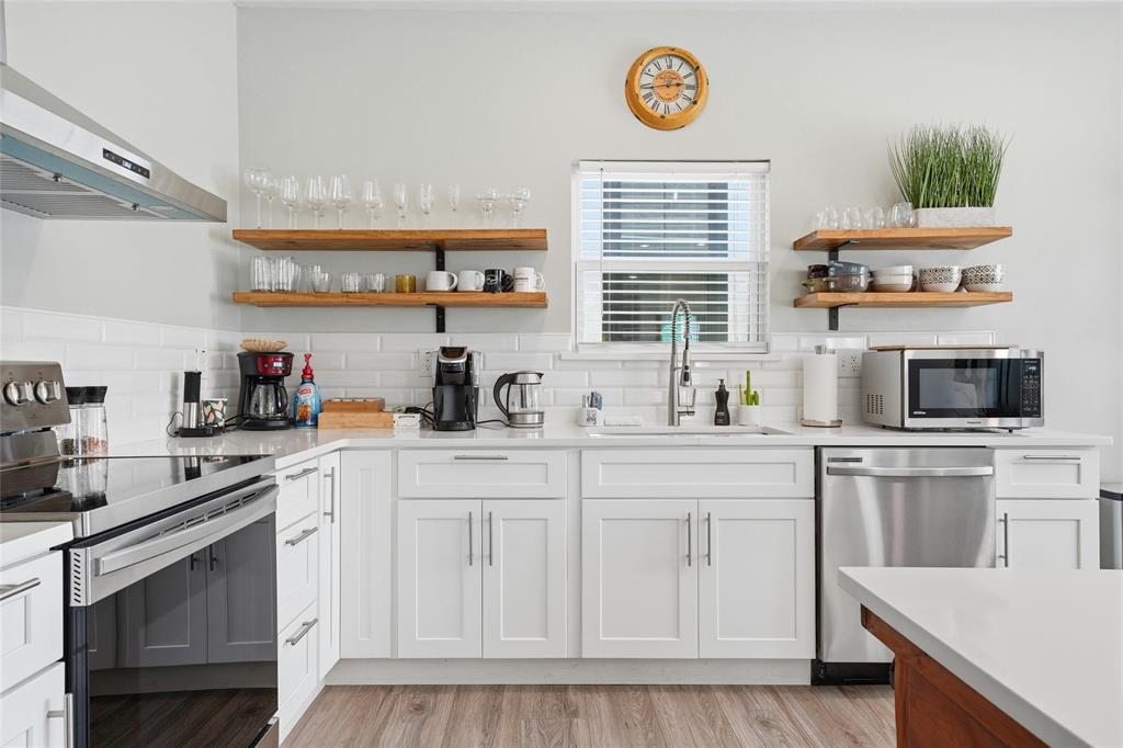 708 South 9th Street Waco, TX 76706 - Photo 11 of 26 a kitchen with stainless steel appliances granite countertop a stove a sink and a microwave