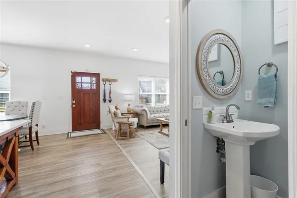 a bathroom with a toilet sink and mirror