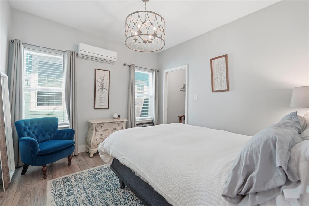 708 South 9th Street Waco, TX 76706 - Photo 13 of 26 a spacious bedroom with a bed a couch and a dresser next to a window