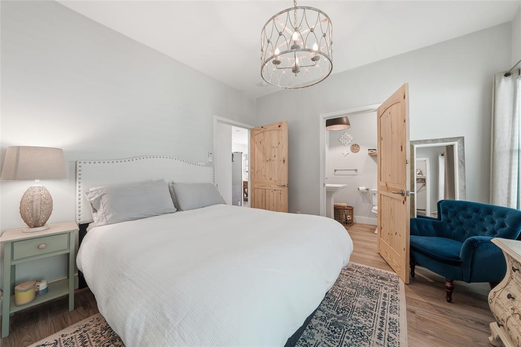 708 South 9th Street Waco, TX 76706 - Photo 14 of 26 a spacious bedroom with a bed and a chair in it