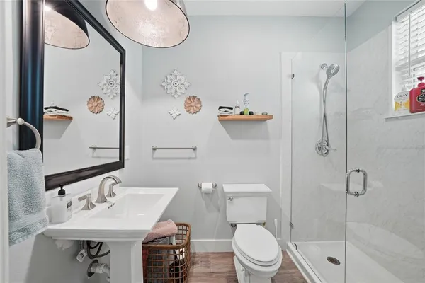 a bathroom with a sink toilet and shower