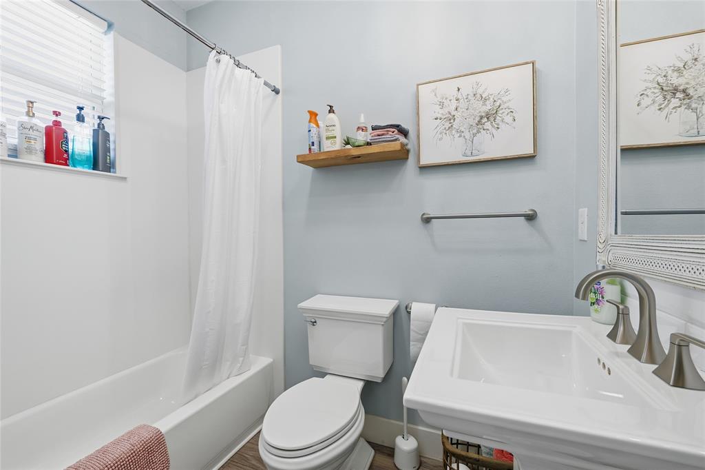 708 South 9th Street Waco, TX 76706 - Photo 18 of 26 a white toilet sitting next to a bathroom sink