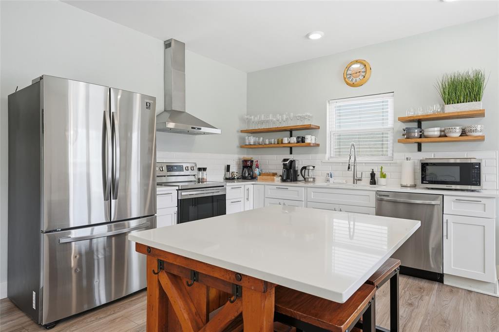 708 South 9th Street Waco, TX 76706 - Photo 10 of 26 a kitchen with stainless steel appliances white cabinets and wooden floor