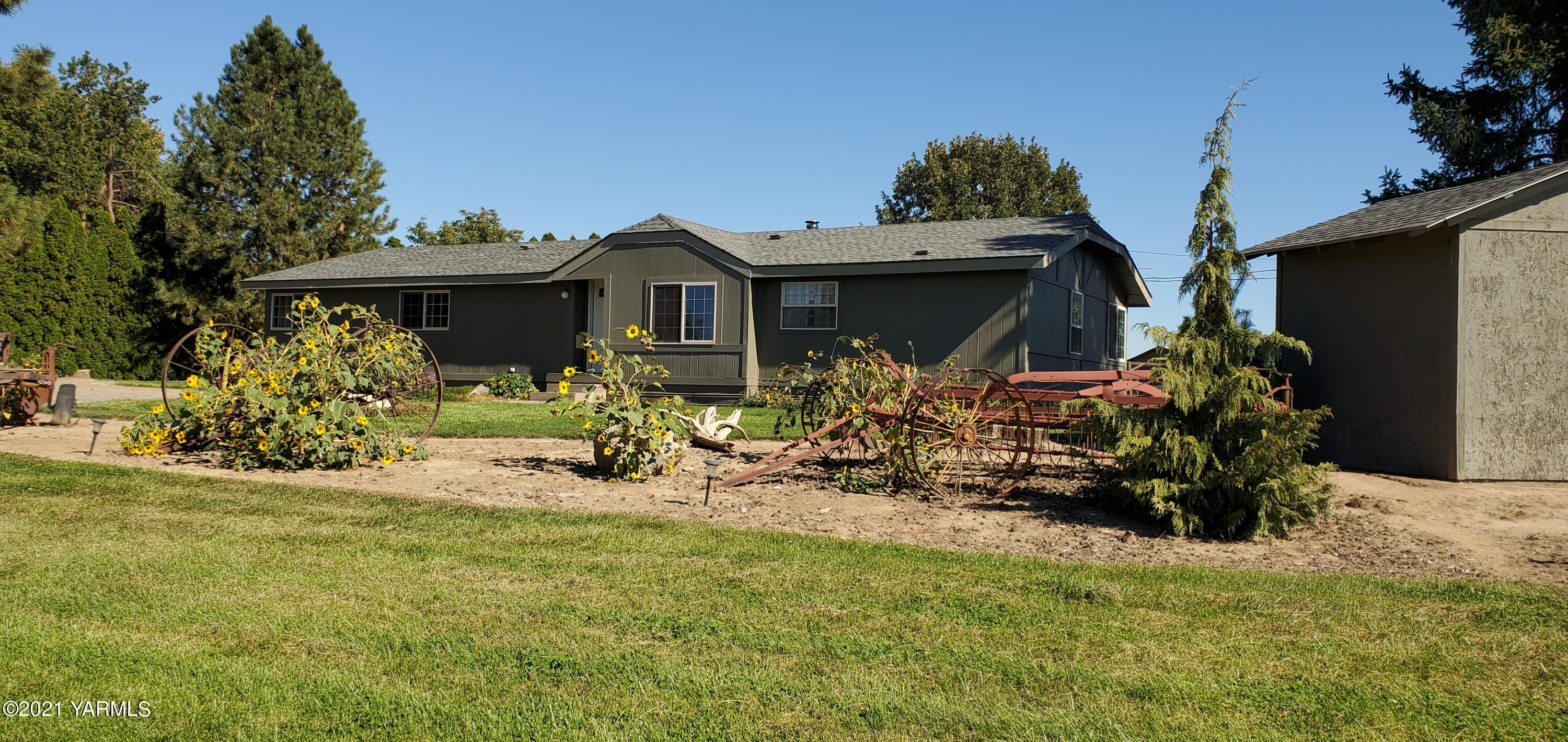 a view of a house with many windows next to a yard