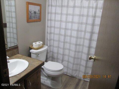 861 Hinman Road Harrah, WA 98933 - Photo 15 of 23 a white toilet sitting next to a bathroom sink