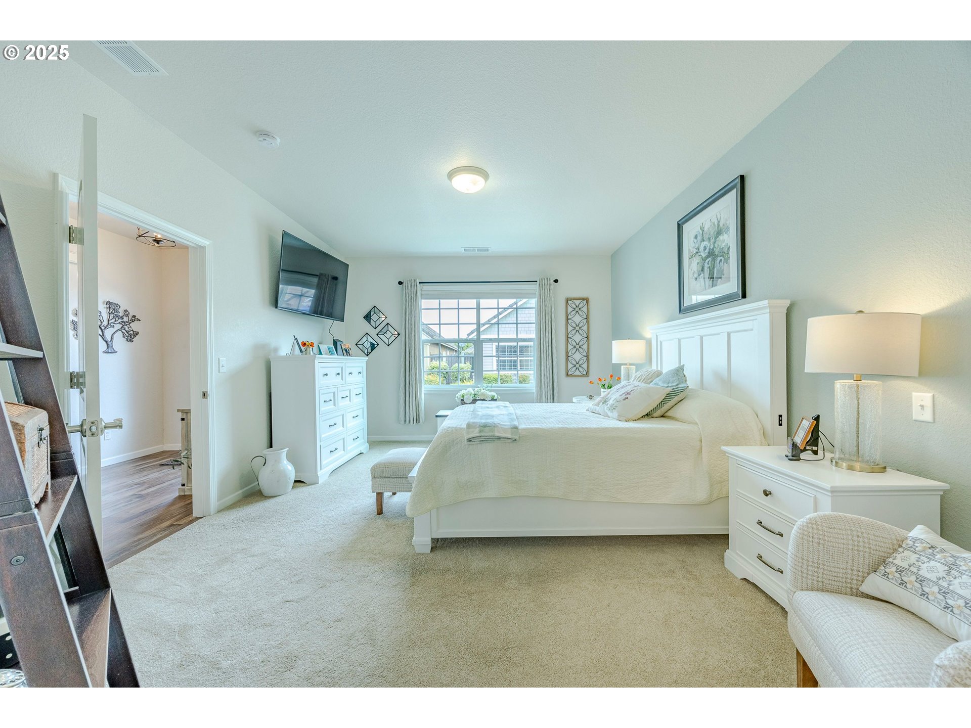 2024 Lake Shore Drive Eugene, OR 97408 - Photo 17 of 34 a spacious bedroom with a bed a couch and a large window