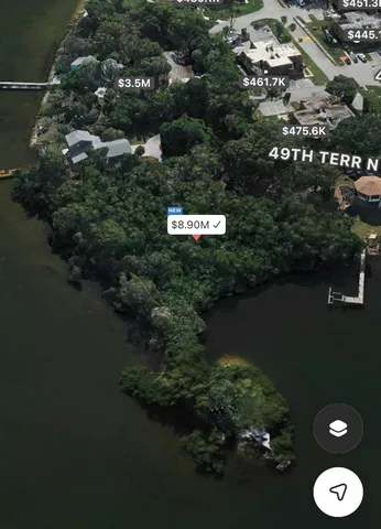 an aerial view of a residential houses with outdoor space and trees