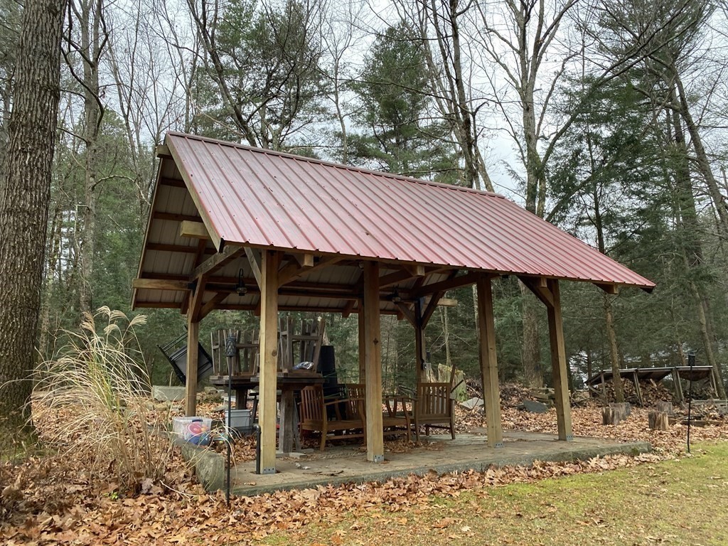 164 Pierce Road Townsend, MA 01469 - Photo 17 of 23 a view of a patio with table and chairs under an umbrella