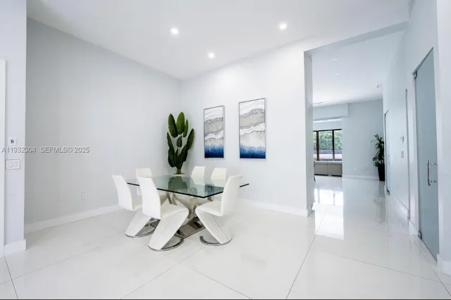 a living room with furniture a dining table and chairs