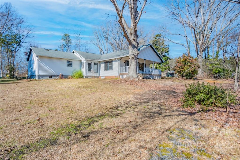 2501 Whitley Road Fort Mill, SC 29708 - Photo 2 of 46 a front view of a house with a dirt yard and a large tree