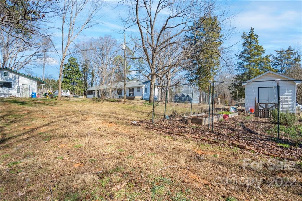 2501 Whitley Road Fort Mill, SC 29708 - Photo 28 of 46 a backyard of a house with wooden fence and large trees