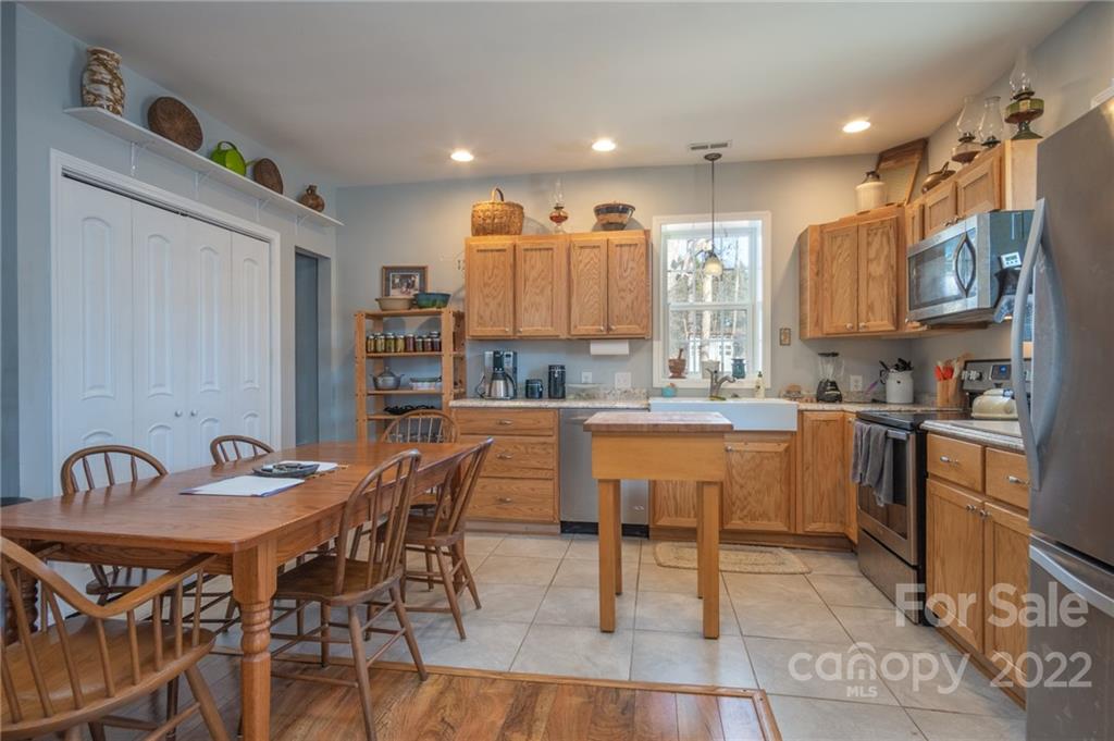 2501 Whitley Road Fort Mill, SC 29708 - Photo 36 of 46 a kitchen with stainless steel appliances kitchen island granite countertop a sink and cabinets
