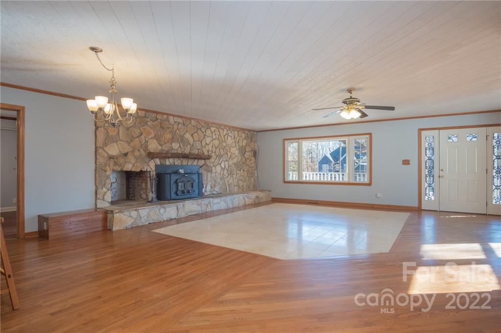 2501 Whitley Road Fort Mill, SC 29708 - Photo 7 of 46 an empty room with wooden floor fireplace and window