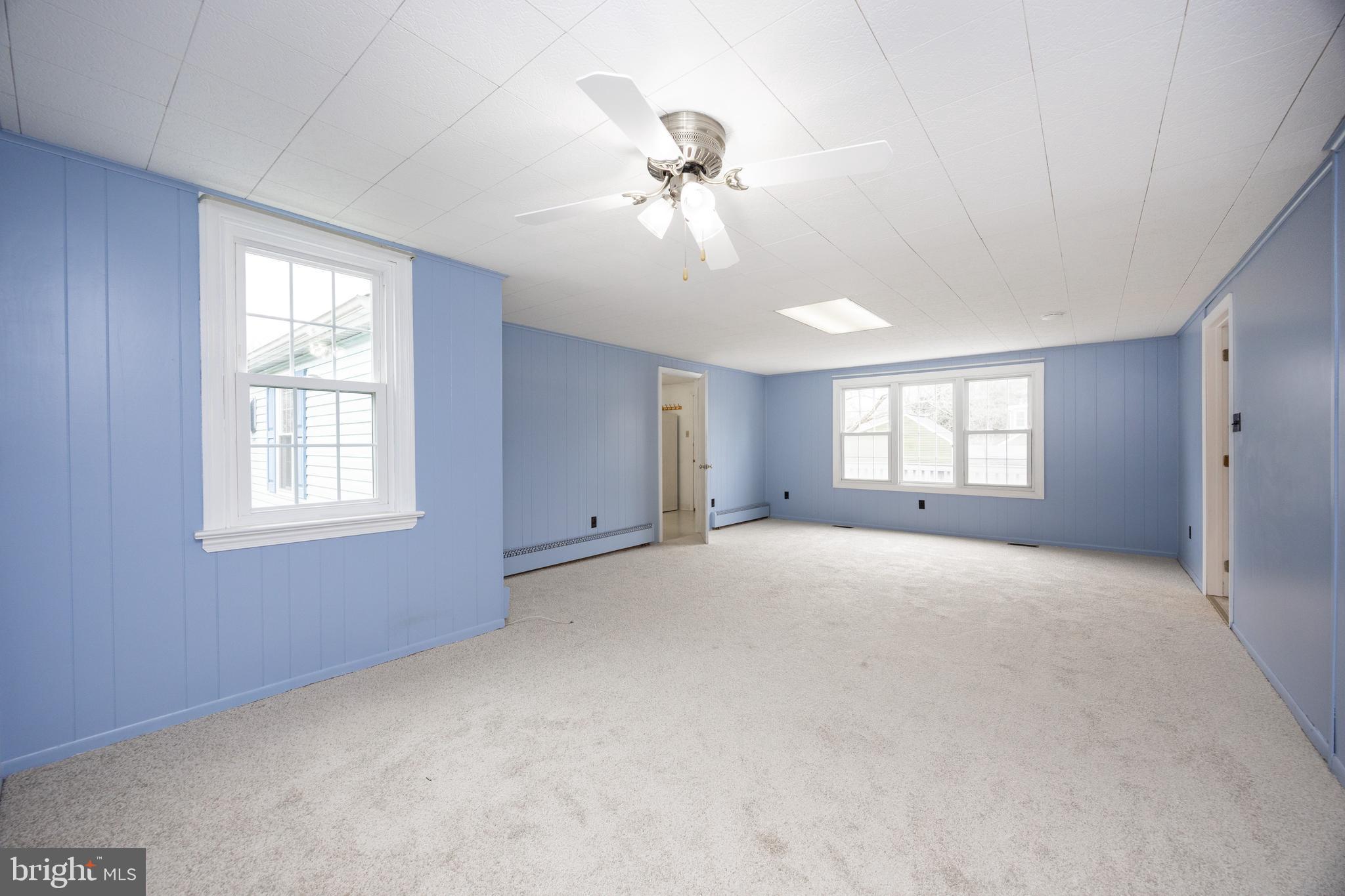 933 Forty Foot Road Hatfield, PA 19440 - Photo 11 of 28 a view of a big room with windows and chandelier fan