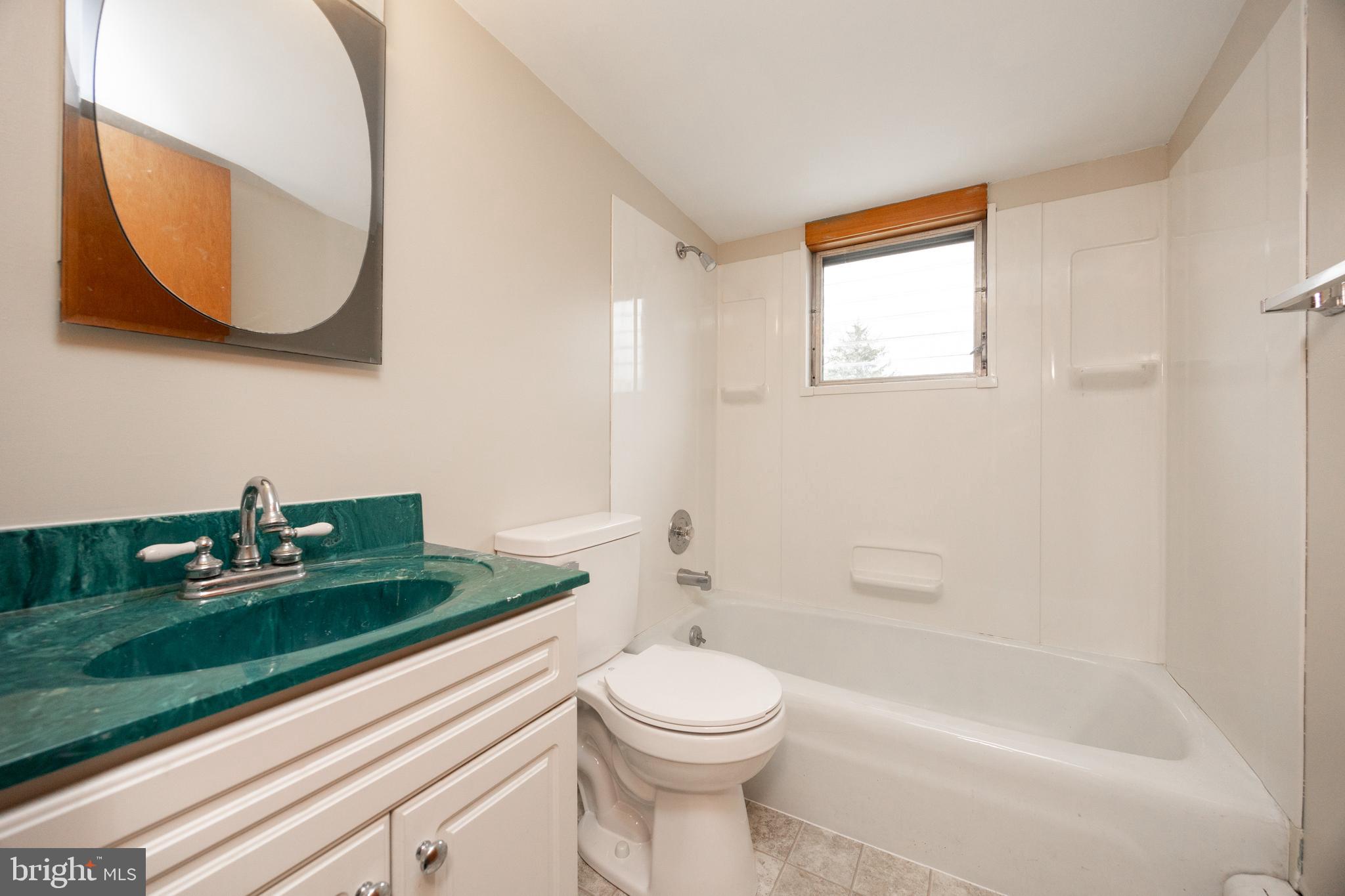 933 Forty Foot Road Hatfield, PA 19440 - Photo 17 of 28 a bathroom with a sink a toilet and a mirror