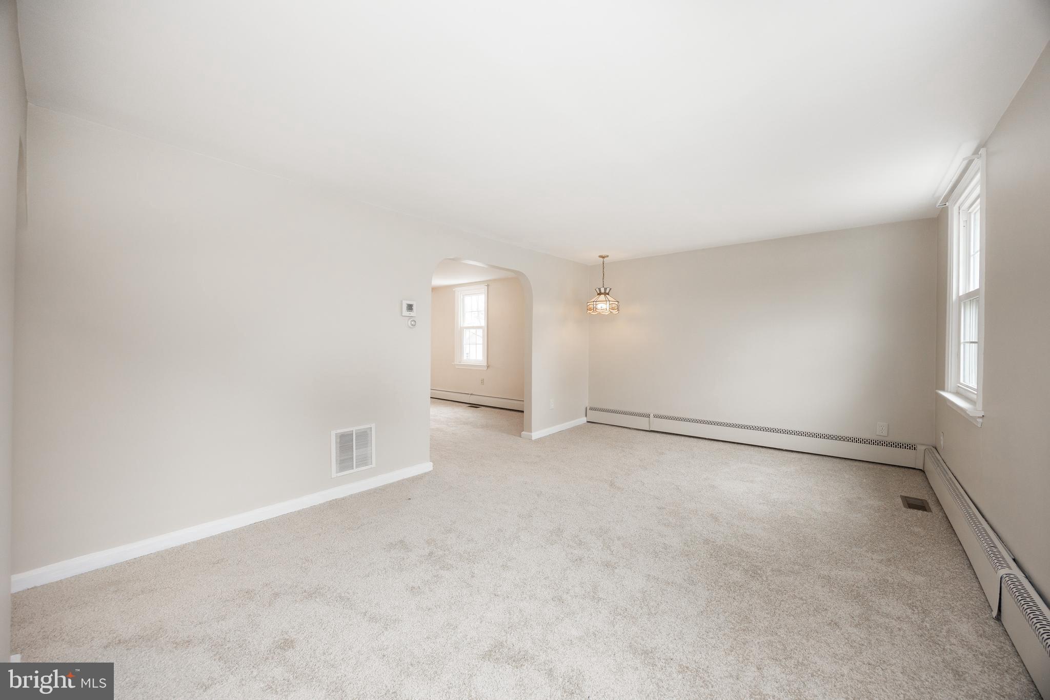 933 Forty Foot Road Hatfield, PA 19440 - Photo 6 of 28 an empty room with windows and white walls