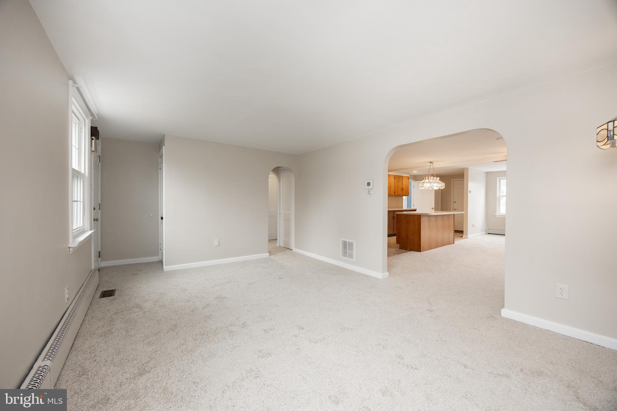 933 Forty Foot Road Hatfield, PA 19440 - Photo 7 of 28 an empty room with kitchen and windows