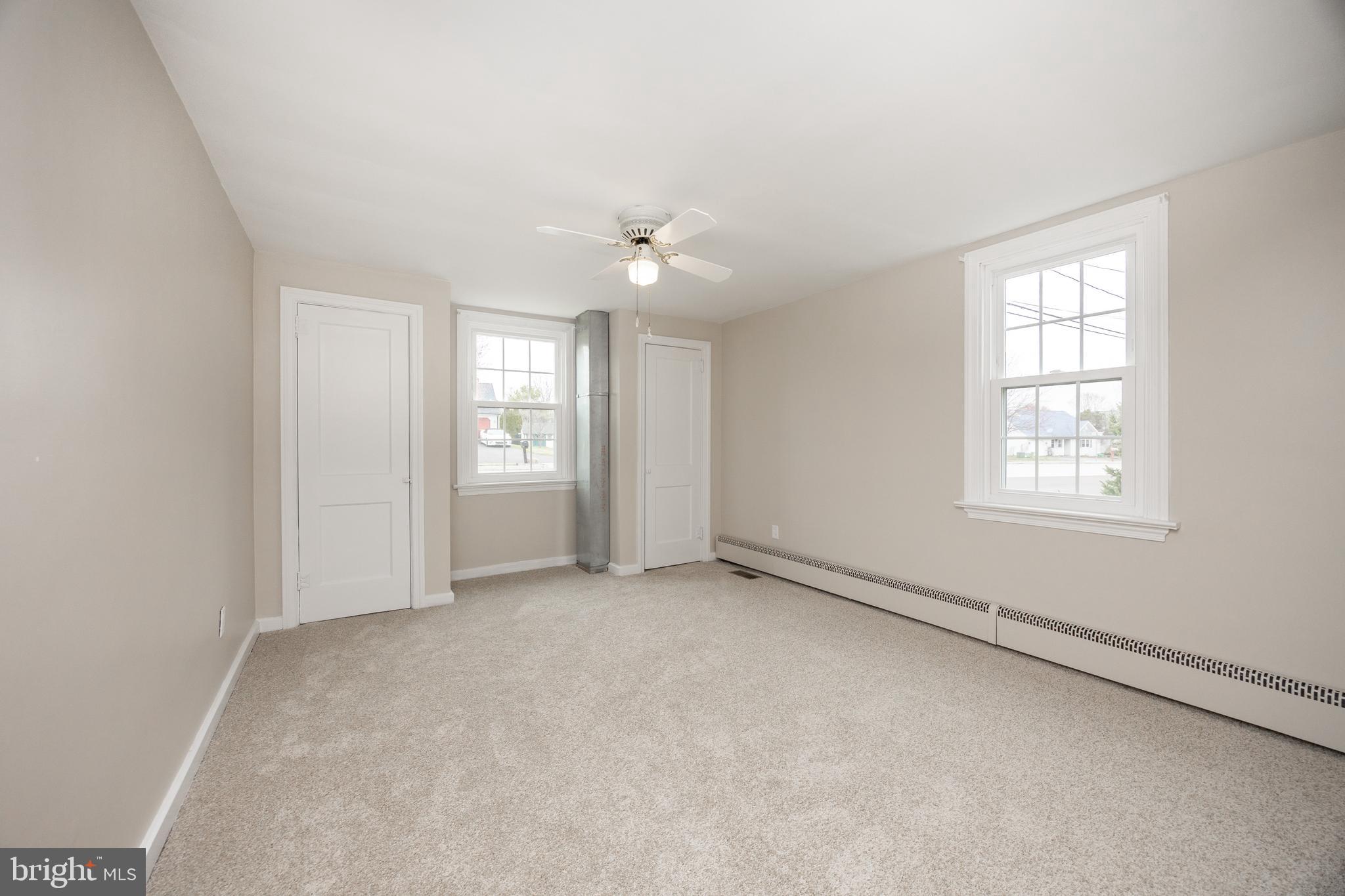 933 Forty Foot Road Hatfield, PA 19440 - Photo 8 of 28 an empty room with windows and ceiling fan