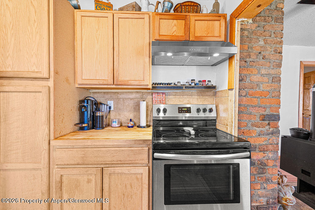 604 Tucker Street Craig, CO 81625 - Photo 11 of 35 a kitchen with stainless steel appliances granite countertop a stove and a microwave