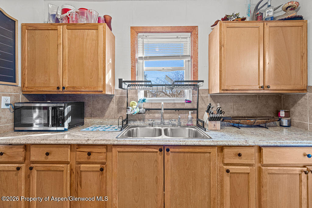 604 Tucker Street Craig, CO 81625 - Photo 12 of 35 a kitchen with granite countertop stainless steel appliances a sink and cabinets