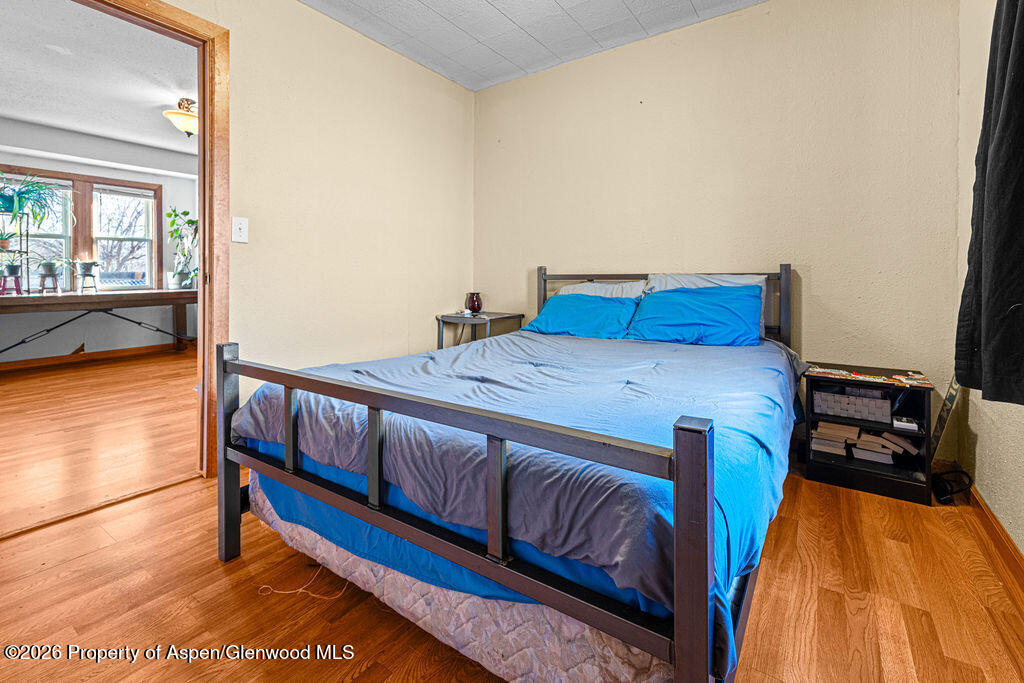 604 Tucker Street Craig, CO 81625 - Photo 14 of 35 a bed sitting in a bedroom next to a window