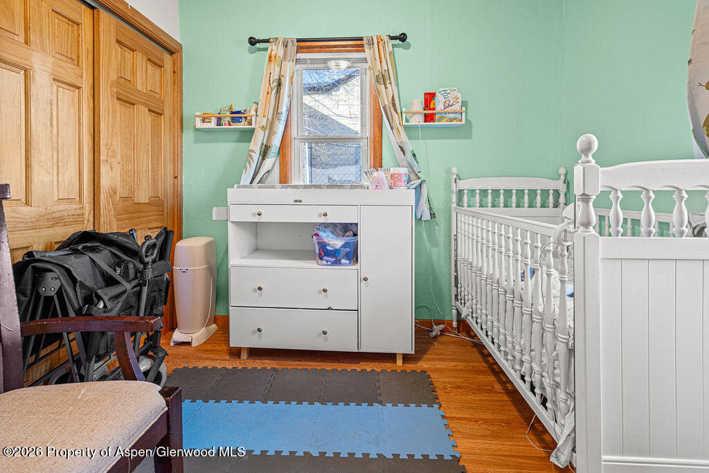 604 Tucker Street Craig, CO 81625 - Photo 20 of 35 a room with furniture a baby crib and a dresser