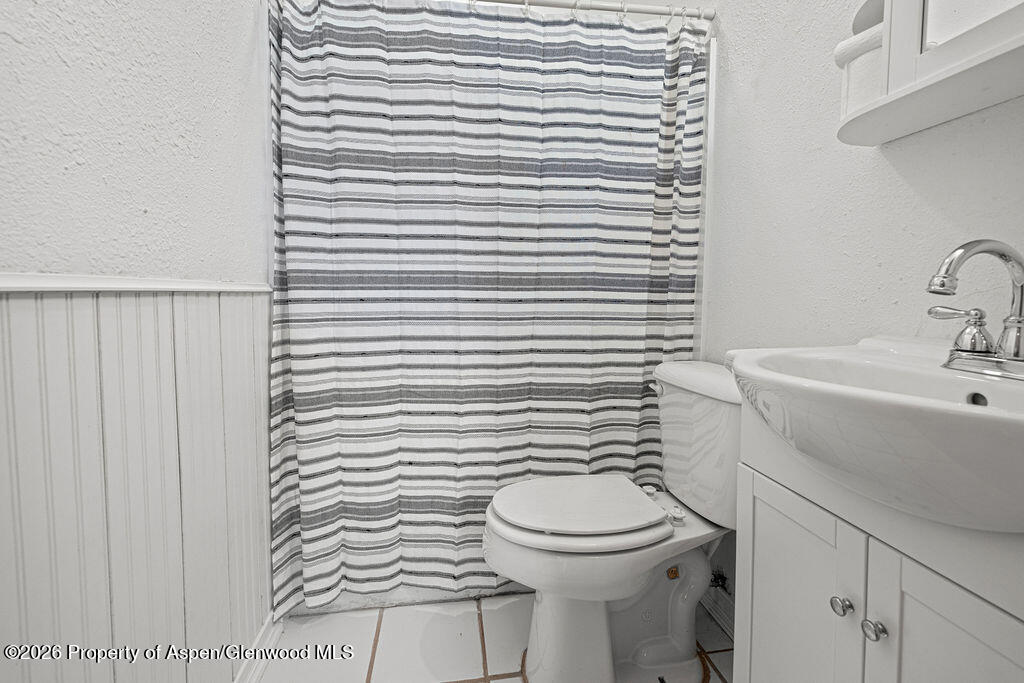 604 Tucker Street Craig, CO 81625 - Photo 22 of 35 a bathroom with a toilet a sink and a window