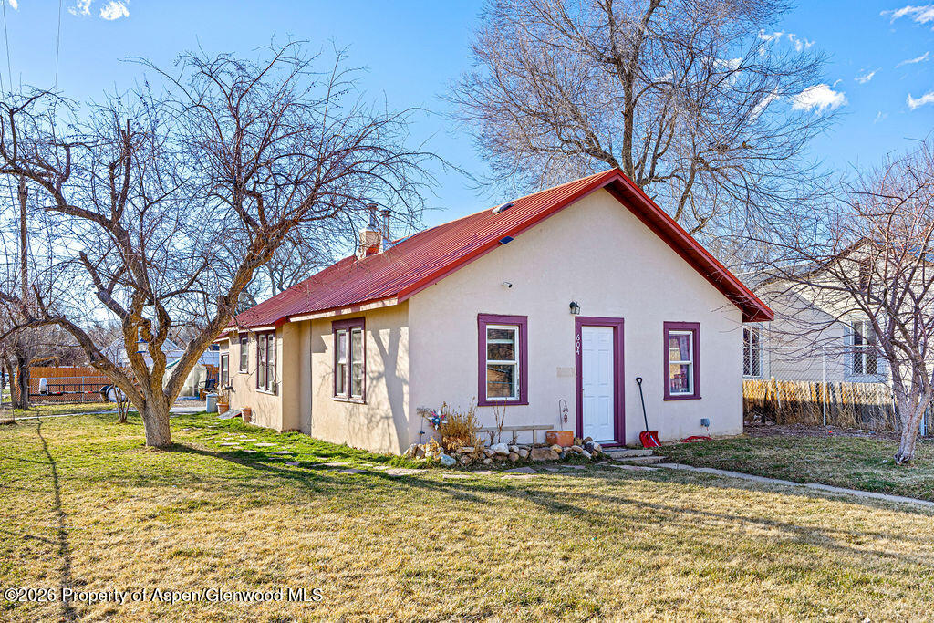 604 Tucker Street Craig, CO 81625 - Photo 27 of 35 a view of a house with a yard and large tree