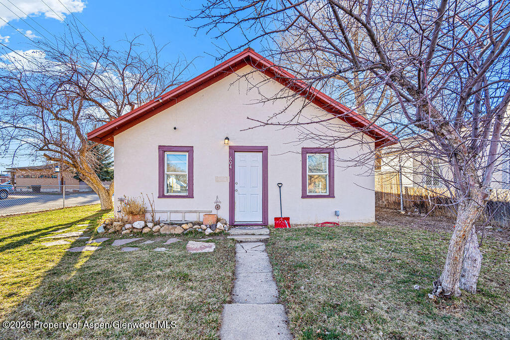 604 Tucker Street Craig, CO 81625 - Photo 3 of 35 a front view of house with yard and trees in the background
