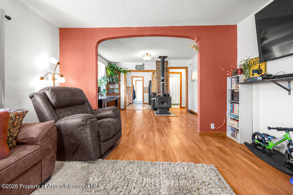 604 Tucker Street Craig, CO 81625 - Photo 4 of 35 a living room with furniture hard wood floor and a flat screen tv