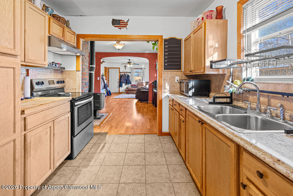 604 Tucker Street Craig, CO 81625 - Photo 10 of 35 a large kitchen with stainless steel appliances granite countertop a large counter top a stove a sink and dishwasher