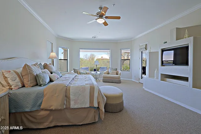 a living room with furniture and a ceiling fan