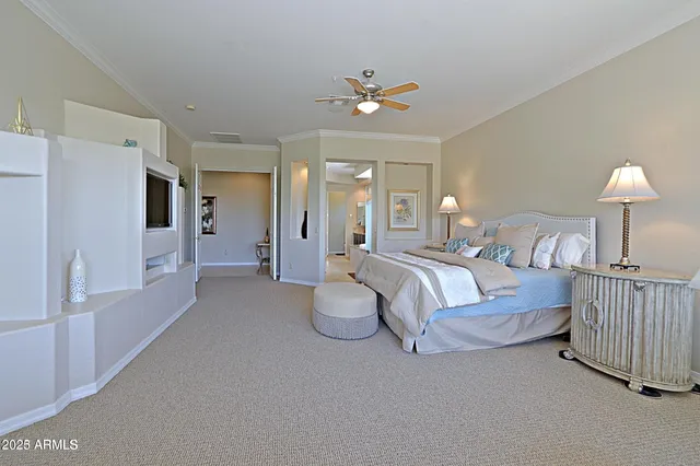 a spacious bedroom with a bed and a chandelier