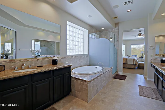 a spacious bathroom with a sink double vanity shower and a mirror