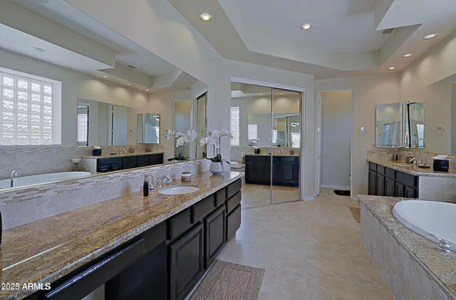a large bathroom with double vanity and a large mirror