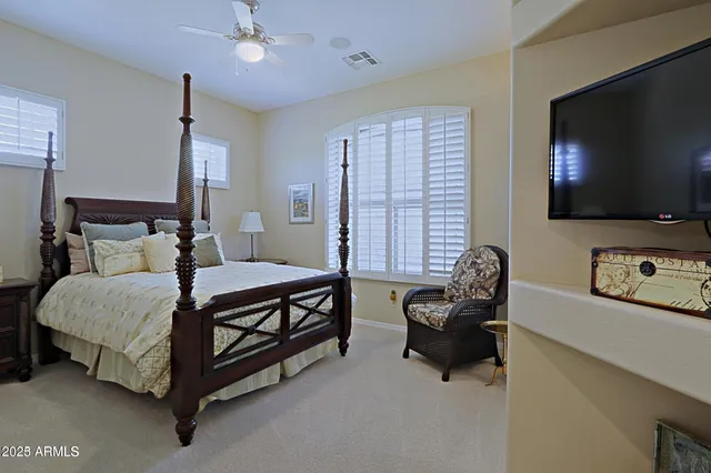 a bedroom with a bed and a flat screen tv