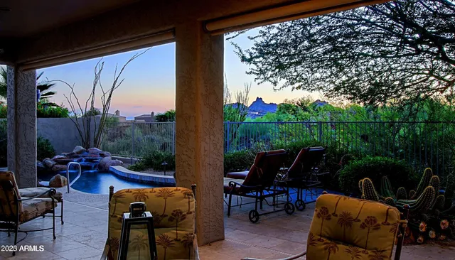 a view of yard from deck with patio