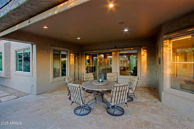 a dining room with furniture water view and a floor to ceiling window