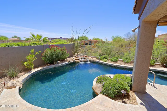 a view of a swimming pool with a lounge chair