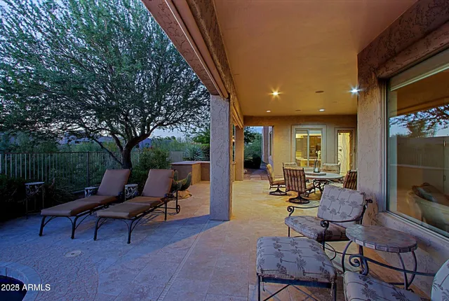 a view of a patio with couches table and chairs and potted plants