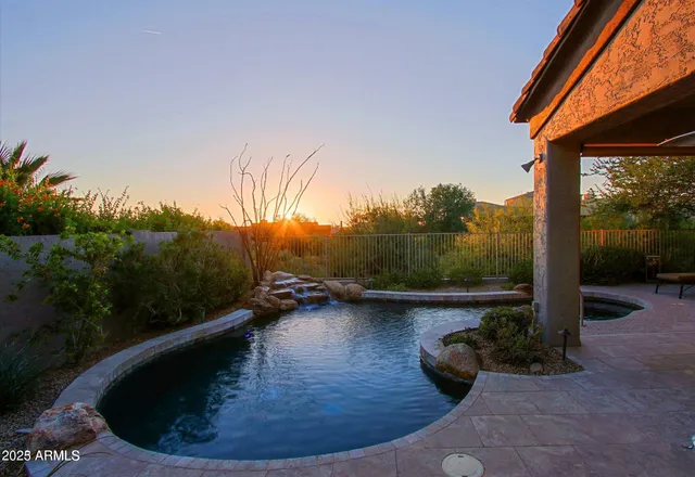 a view of a swimming pool in the backyard