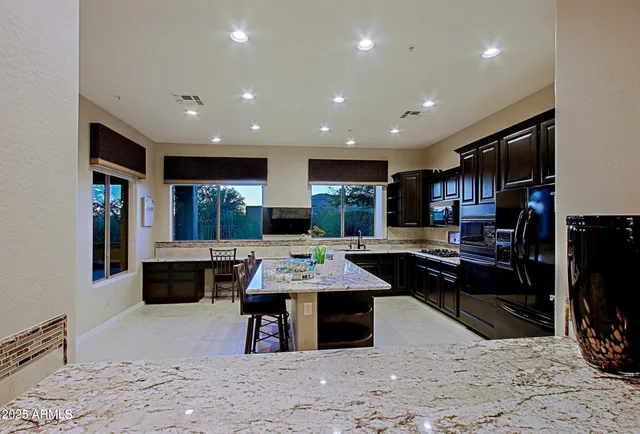 a large kitchen with a table and chairs