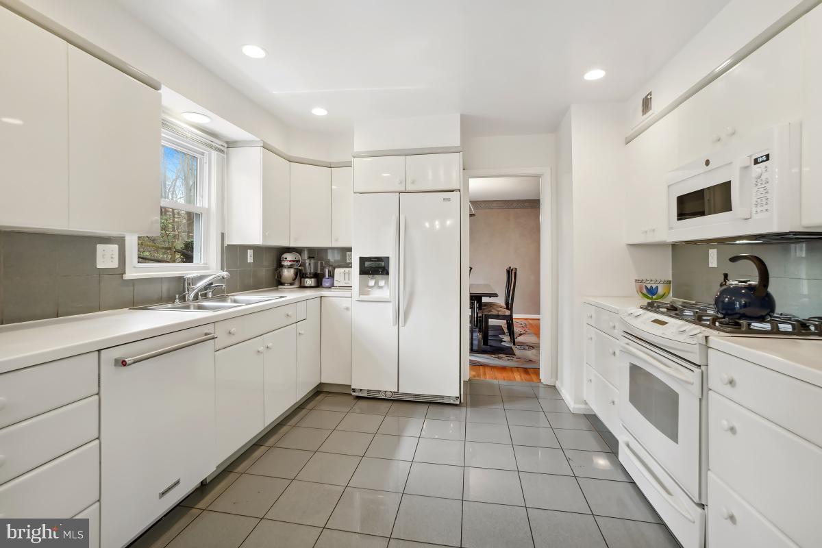 7802 Ivymount Terrace Potomac, MD 20854 - Photo 14 of 51 a kitchen with white cabinets appliances and a sink